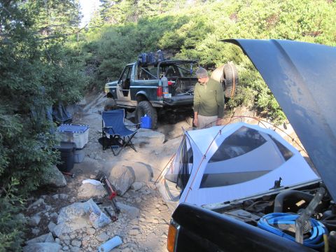 1989 Ford Bronco - Off-road campsite setup with a 1989 Ford Bronco and camping equipment.