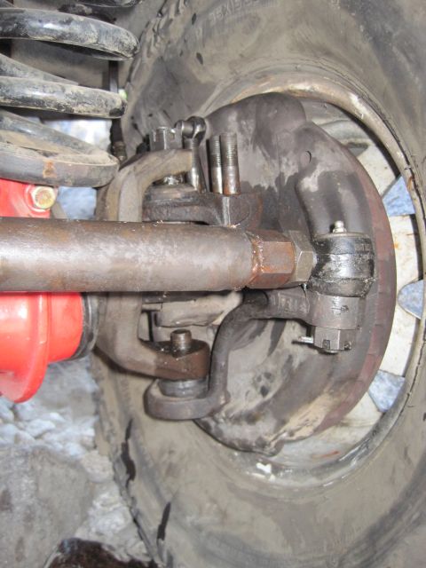 1989 Ford Bronco - Detailed view of the steering and suspension system, focusing on the tie rod and ball joints.