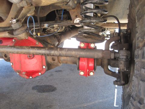 1989 Ford Bronco - Undercarriage view of a vehicle's front axle, showing suspension and differential parts.