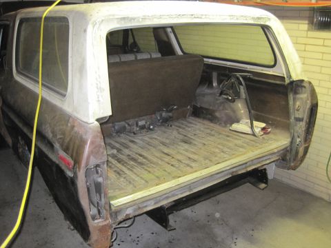 1979 Ford Bronco - The rear of a 1978 Ford Bronco is shown with the tailgate down, revealing the cargo bed and interior seating.