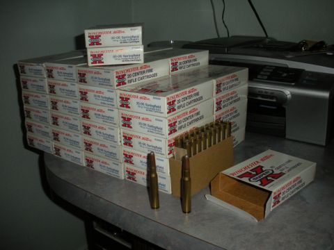 1996 Ford Bronco - Boxes of Winchester 30-06 Springfield rifle cartridges are stacked on a table next to loose ammunition.