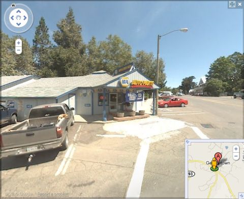 1989 Ford Bronco - A gray pickup truck is parked in front of a NAPA Auto Parts store on a sunny day.
