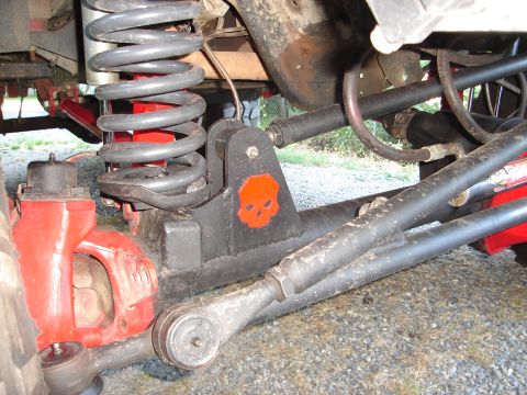 1989 Ford Bronco - Close-up of off-road vehicle suspension components, including a differential and coil spring.
