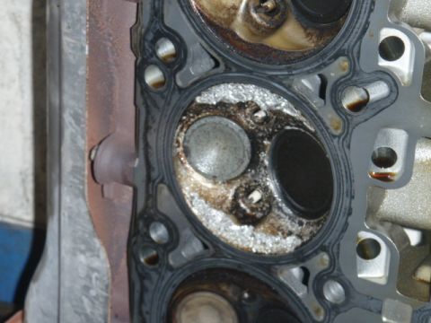 2006 Dodge Charger - Close-up of a damaged engine cylinder head, indicating internal engine problems.