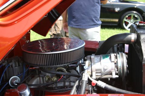 1968 Shelby GT500 - Close-up of an engine bay, with another car visible in the background.