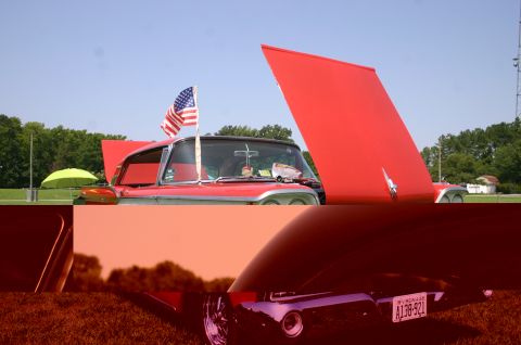 1968 Shelby GT500 - A red convertible is displayed with its hood open, flying an American flag on the fender.