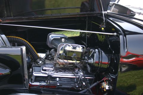 1968 Shelby GT500 - Close-up of a car's engine bay, revealing a Chevrolet V8 engine with chrome accents.