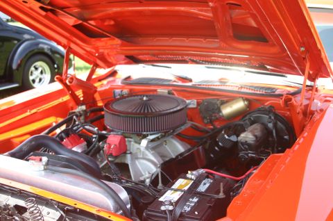 1968 Shelby GT500 - Engine bay of an orange car with a black car visible in the background.