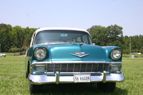 1968 Shelby GT500 - A classic 1956 Chevrolet wagon is parked on a grassy field under a clear blue sky.