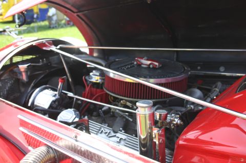 1968 Shelby GT500 - Close-up of a classic car's engine bay, a V8 engine and a miniature car on the air cleaner.