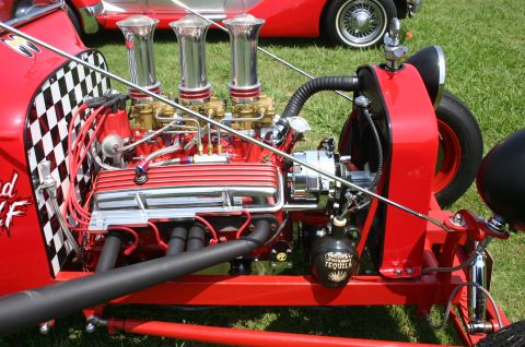 1968 Shelby GT500 - A highly customized hot rod engine features triple carburetors and a striking checkerboard fender, with a decorative tequila bottle adding…