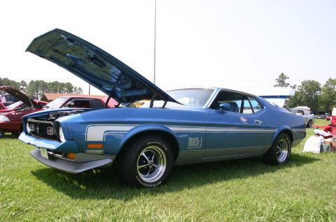 1968 Shelby GT500 - 1971 Ford Mustang Mach 1 on display at a car show, hood is open showing the engine bay.