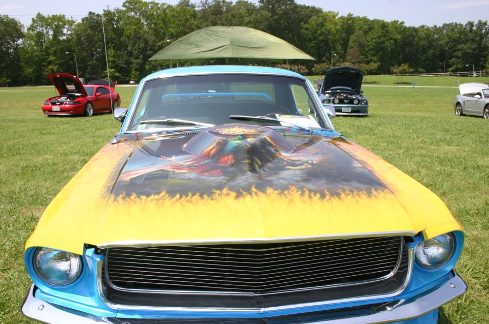 Blue 1968 Mustang with custom hood art and flames