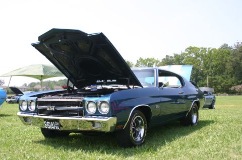 1968 Shelby GT500 - A blue 1970 Chevrolet Chevelle SS is displayed with its hood and trunk open at a car show.