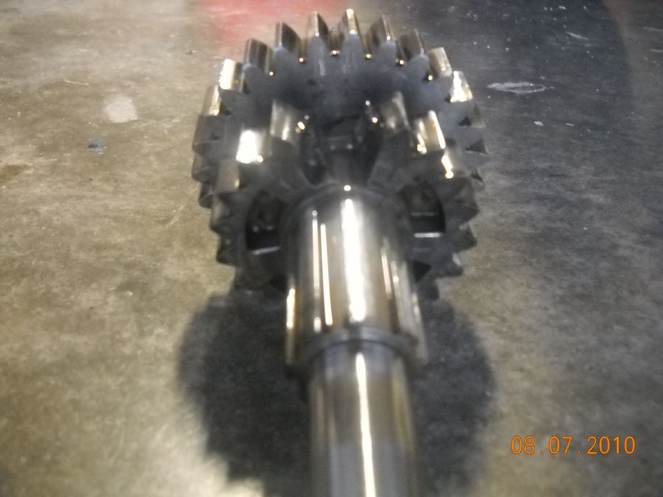 Close-up of a metal gear with many teeth on a shaft
