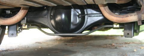 1976 Ford Ranchero - Underside view of a vehicle's rear axle and suspension system, including exhaust pipes.
