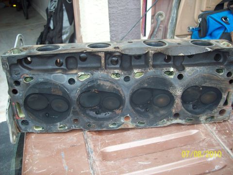 1985 Ford Bronco - A used engine cylinder head is shown, with visible carbon deposits on the valves.