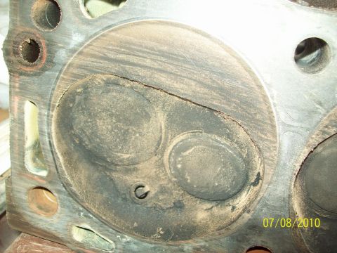 1985 Ford Bronco - Close-up of an engine cylinder head showing wear and carbon deposits, dated 07/08/2010.