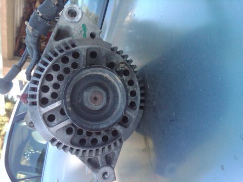 1982 Ford Bronco - Close-up of an automotive alternator, a key component for charging a vehicle's battery.