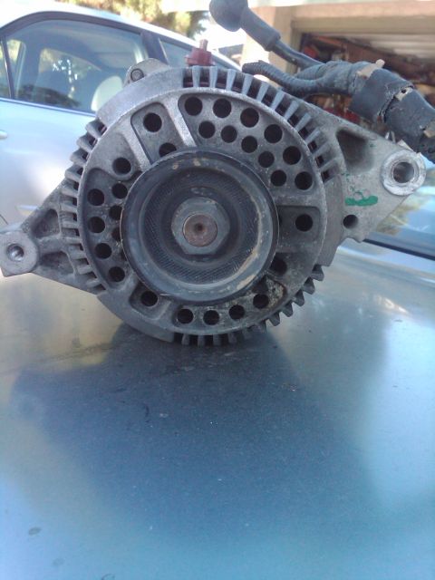 1982 Ford Bronco - This is a close-up view of a vehicle's alternator, a crucial component for generating electrical power.