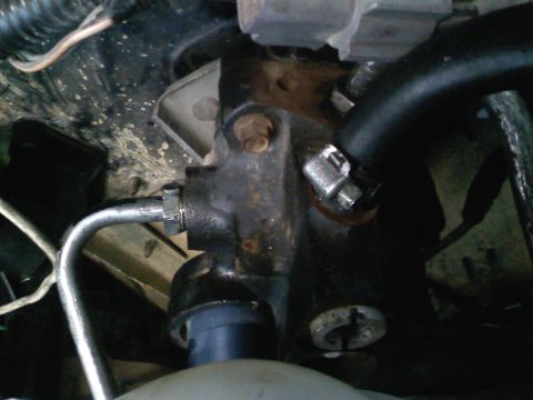 1990 Ford Bronco - Close-up of a brake master cylinder, part of a vehicle's braking system.