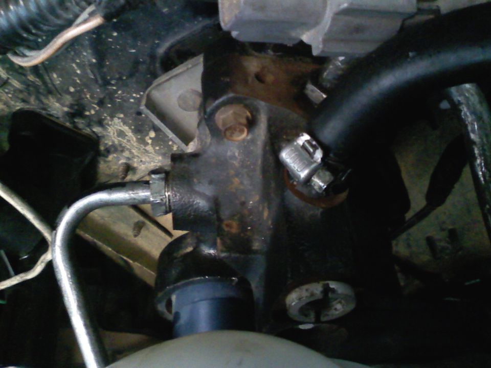 Brake master cylinder with metal lines and black hose attached