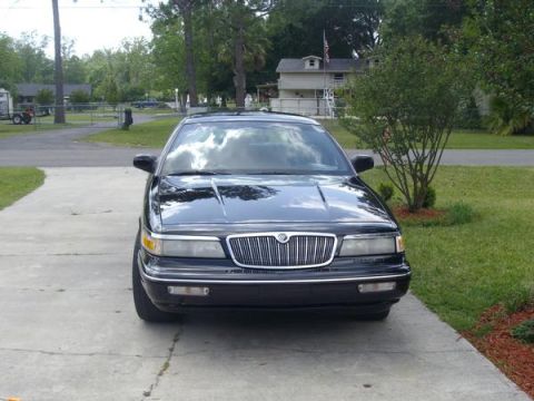 1995 Mercury Grand Marquis - The front grille and headlights are clearly visible on this black sedan.