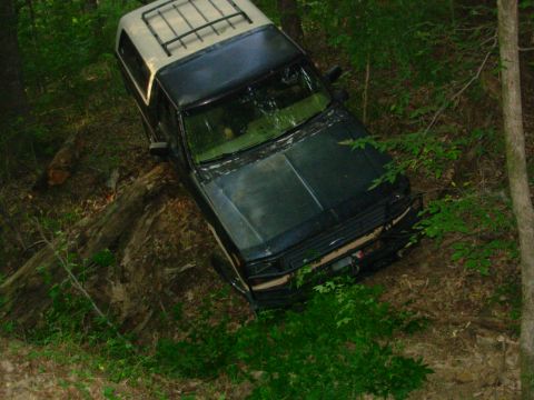 1983 Ford Bronco - The camera is looking horizontally, but it's rotated slightly CW. Note the tilt of the tree trunks in the background.
