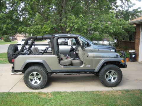 2005 Jeep Wrangler - Side view of a tan 2005 Jeep Wrangler Rubicon with the soft top removed.