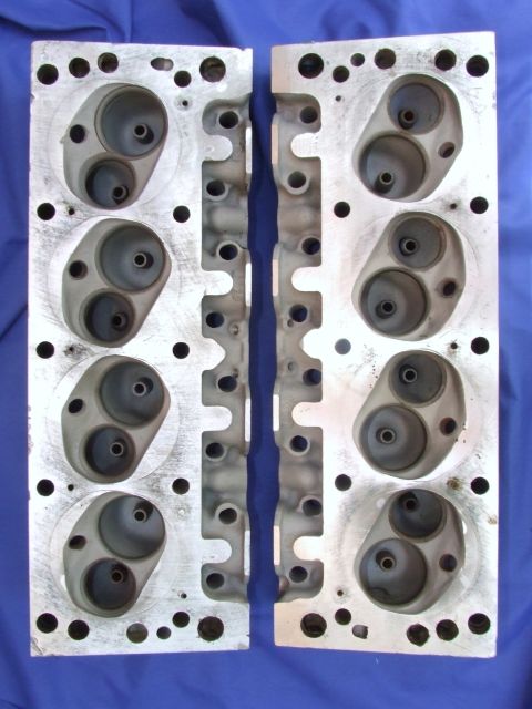 1973 Ford Mustang - A pair of engine cylinder heads are shown from above, revealing their internal port structure.