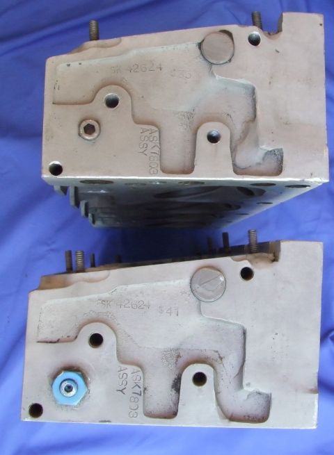 1973 Ford Mustang - Close-up view of two engine cylinder heads, showing casting details and assembly information.