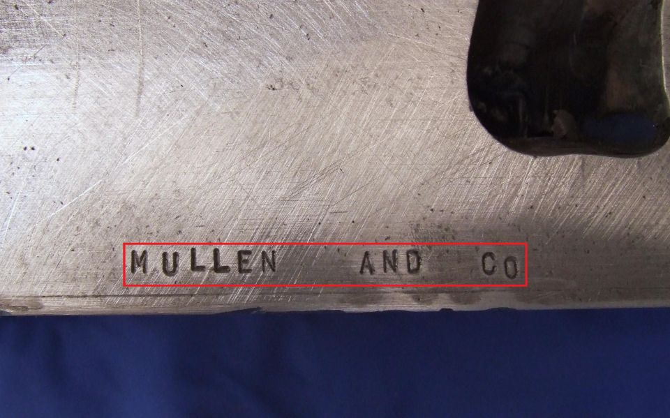Metal part stamped with 'MULLEN AND CO'