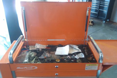 2000 Mercury Grand Marquis - An open orange tool cart, labeled 'Blue-Point', contains various parts and tools. A Supermotors.net logo is visible at the bottom right.