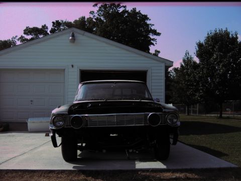 1992 Ford Mustang - Front view of a 1964 Ford Fairlane with its hood open, parked on a concrete driveway in front of a garage.