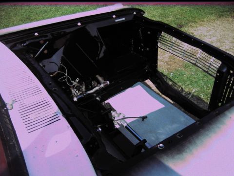 1992 Ford Mustang - The front end of a classic car, likely a 1964 Ford Fairlane, is shown with its engine bay exposed and grille visible.