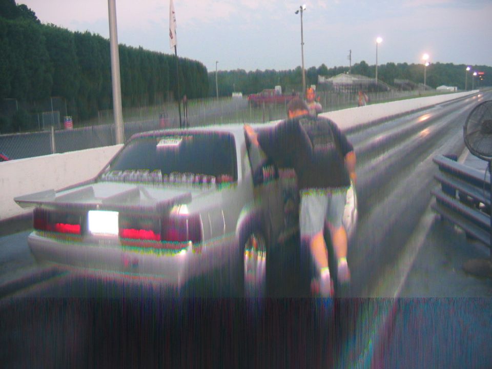 1992 Ford Mustang with a spoiler and racing slicks on a drag strip
