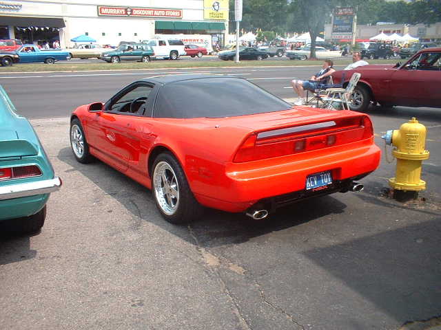 Red sports car with black top, rear view, custom license plate 'KEY TOY'