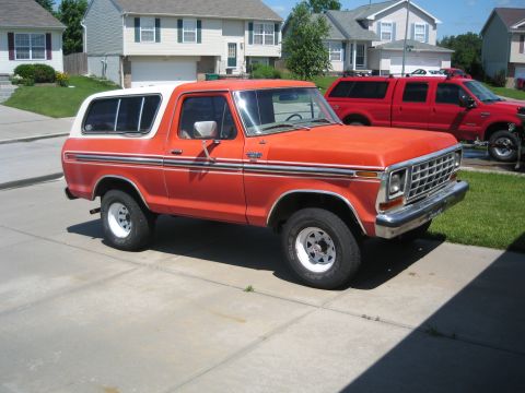 1979 Ford Bronco - This 1979 Ford Bronco features a two-tone orange and white paint scheme with chrome accents and a removable hardtop.