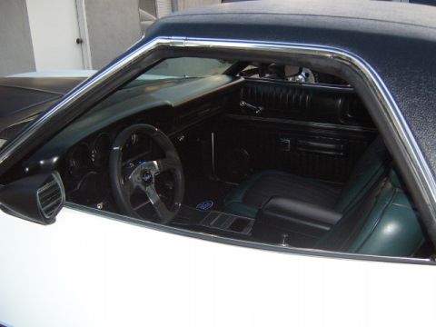 1973 Ford Ranchero - Interior view of a white 1973 Ford Ranchero, showing the dashboard, seats, and steering wheel.