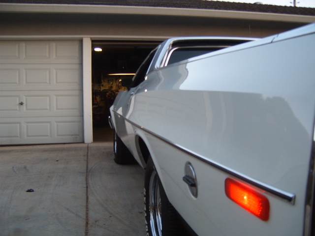 White 1973 Ford Ranchero rear quarter panel with chrome trim and red taillight