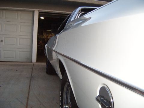 1973 Ford Ranchero - White 1973 Ford Ranchero parked in front of a garage door.