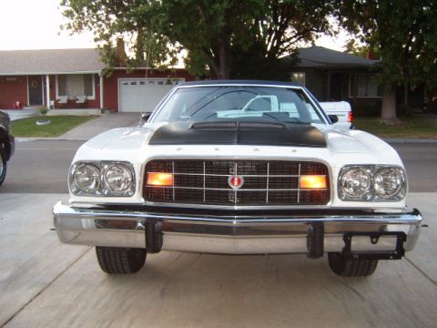 1973 Ford Ranchero - This vehicle has a prominent grille and dual headlights, with amber turn signals.