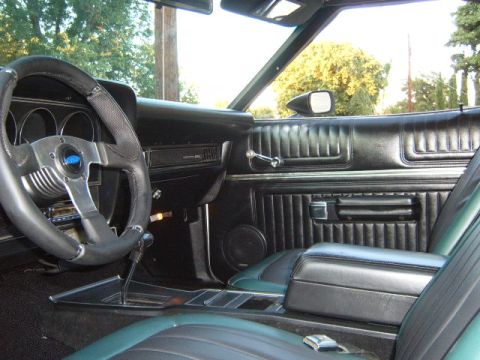 1973 Ford Ranchero - Interior view of a 1973 Ford Ranchero, its dashboard, steering wheel, and seating.