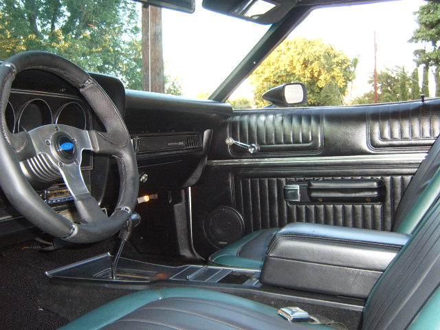 Interior of a 1973 Ford Ranchero showing the dashboard, steering wheel, center console, and seats