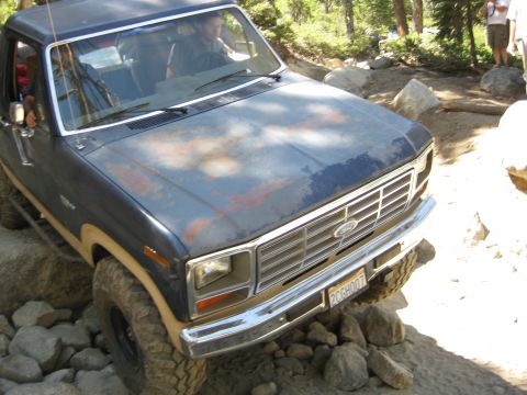 1986 Ford Bronco - This Ford truck is navigating a challenging, rocky off-road path.