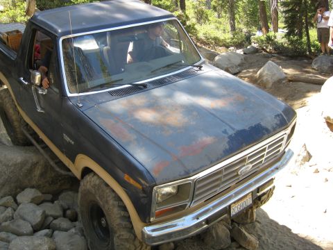 1986 Ford Bronco - This Ford Bronco navigates a rocky trail with its driver behind the wheel.