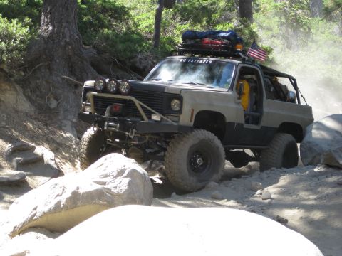 1986 Ford Bronco - This modified 1973 Chevrolet K5 Blazer tackles a challenging rocky trail, equipped for off-road adventure.