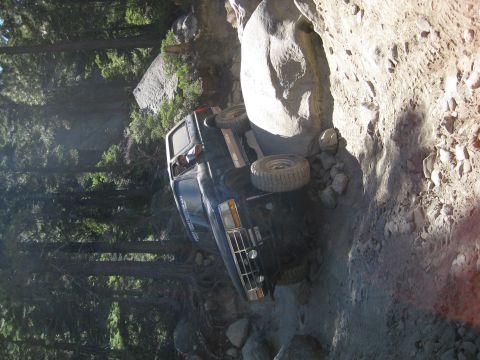 1986 Ford Bronco - Ford Bronco stuck on a steep, rocky off-road trail.