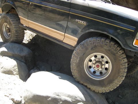 1986 Ford Bronco - 1986 Ford Bronco navigating rocky terrain.
