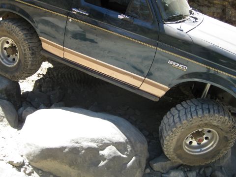 1986 Ford Bronco - This 1986 Ford Bronco is navigating a rocky obstacle on an off-road trail.